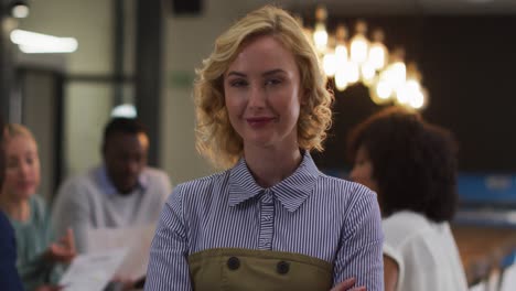 portrait of caucasian businesswoman in a meeting room looking to camera smiling