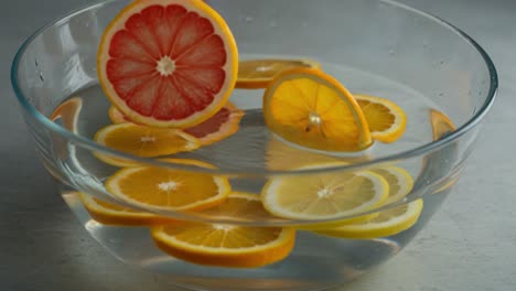 refreshing citrus medley: vibrant lemon and grapefruit slices floating gracefully in clear water, creating a bright and inviting culinary scene