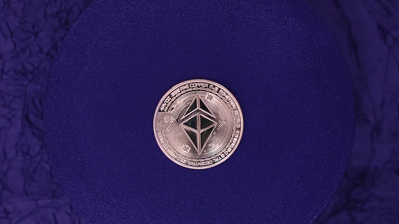 Showcasing a beautifully crafted Ethereum coin on a textured blue surface with intricate designs and symbols