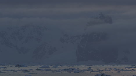 iceberg at sunset with island on the background