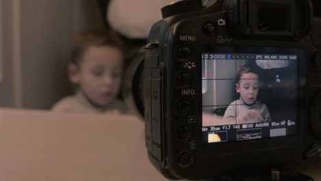 taking video of emotional child playing on pad in train