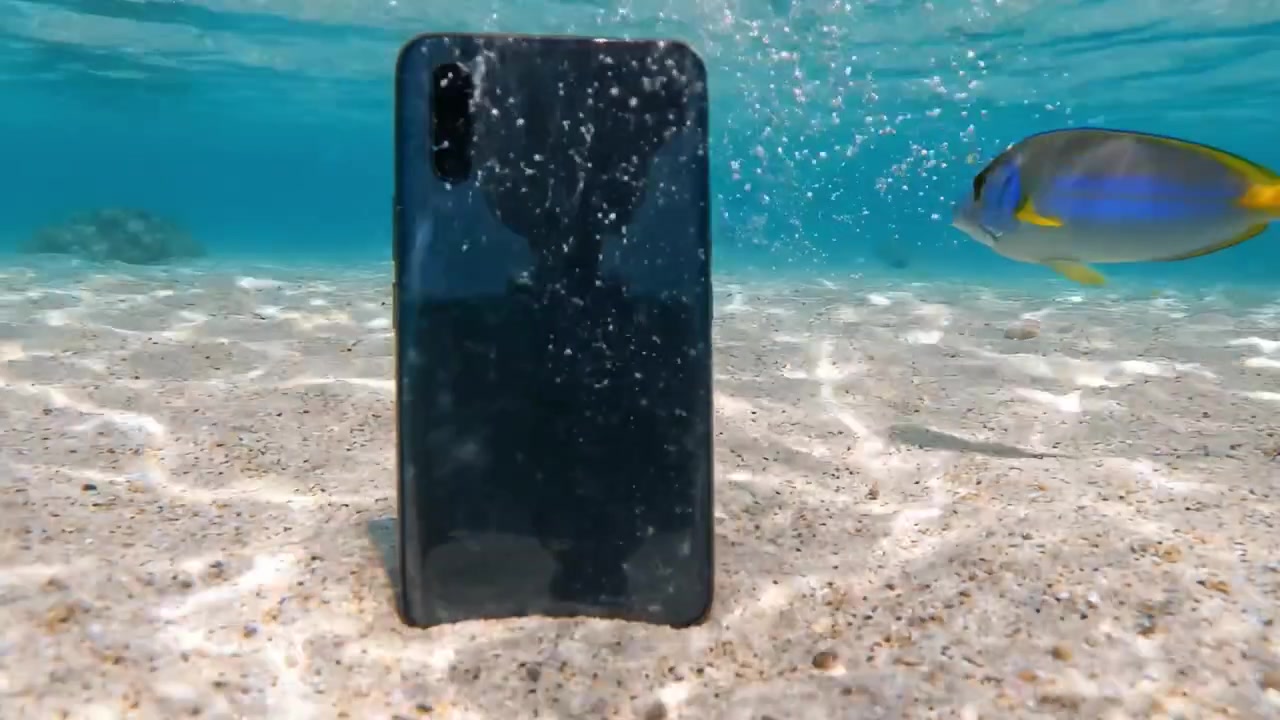 An Underwater Scene Featuring a Smartphone at the Ocean Floor with Pristine Water and Vibrant Marine Atmosphere, Captured in Two Dynamic Frames