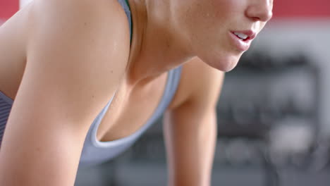 Fit-focused-young-Caucasian-woman-exercising-at-the-gym