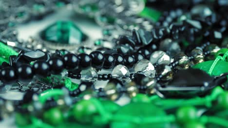 jewelry, beads. close-up. rotation. beautiful shiny, sparkling jewelry with glare in gems. macro. a lot of beads in different colors. various jewelry, stone products, green malachite beads