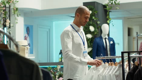 man checking clothes in a clothing store