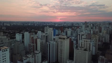 Stunning-aerial-shot-of-downtown-Sao-Paulo,-Brazil-with-buildings-and-red-sky