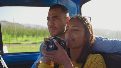 young couple on a road trip in their pick-up truck