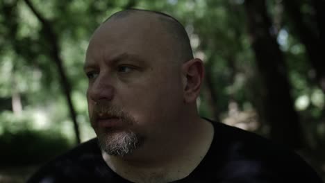 a man walking through forest trees