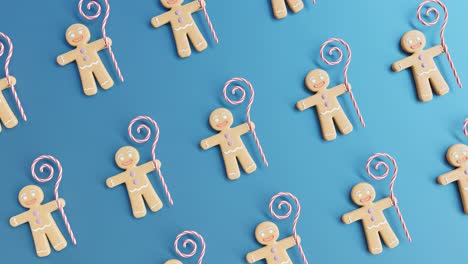 gingerbread men and candy canes on a blue background