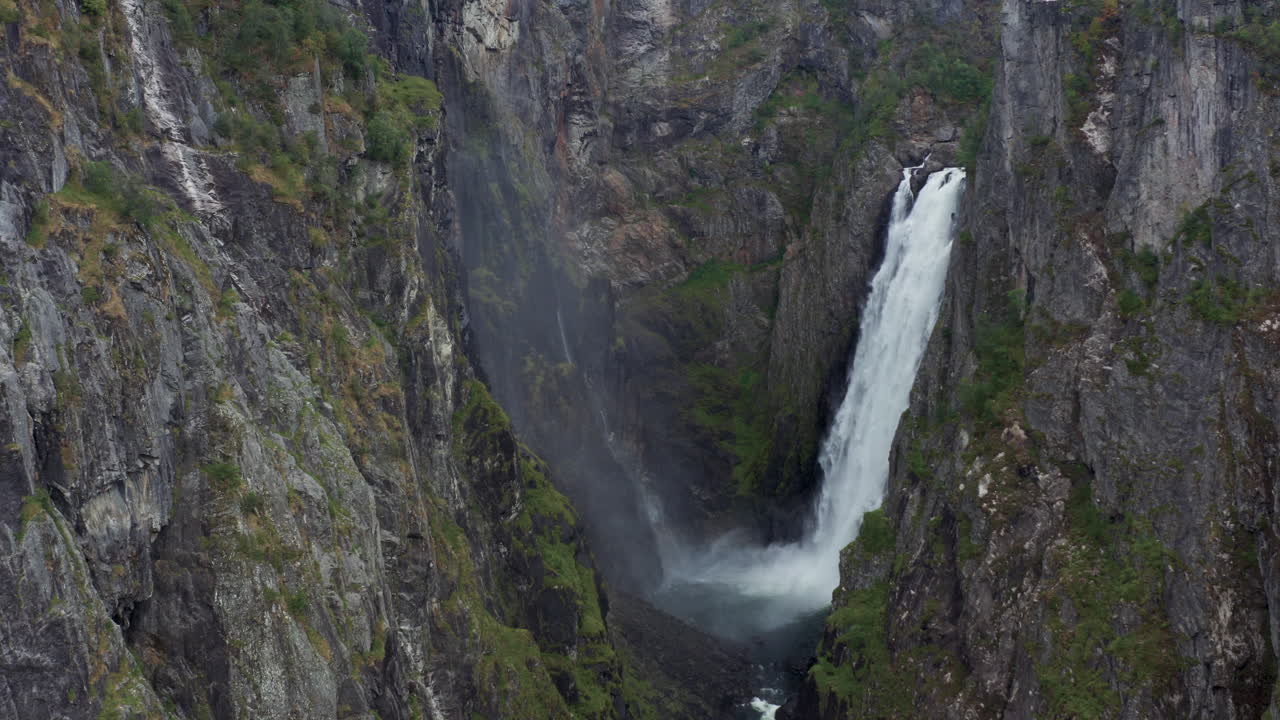 Dramatic Waterfall in a Mountainous Fjord