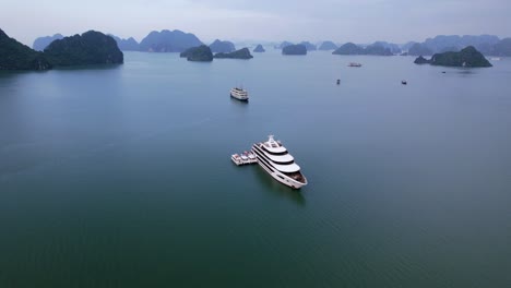 aerial of cruise ships anchored in ha long bay vietnam carrying tourists in tropical water