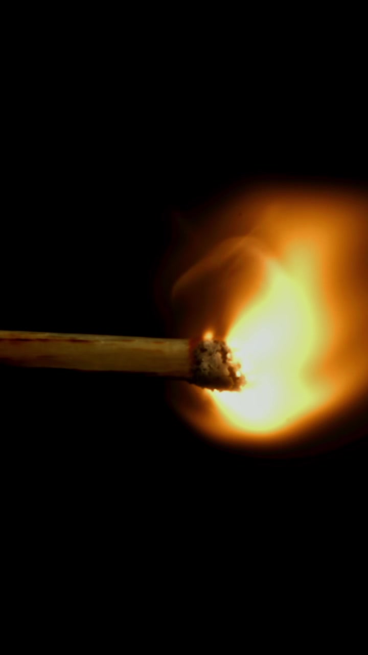 Match Igniting and Burning in Slow Motion on Black Background