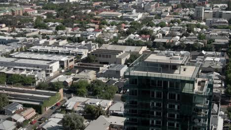 city downtown at sunny day with lots of buildings and roofs in adelaide, australia - aerial drone shot