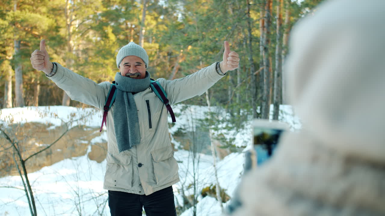 Man Taking Pictures in Snowy Forest
