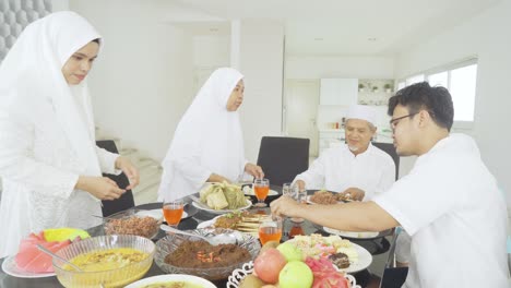 happy muslim family having dinner together
