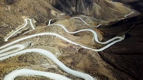 aerial view of a beautiful mountain road and mountain pass at 3000m in kyrgyzstan driving through central asia