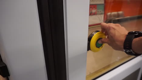 first person shot of a caucasian man opening the door of a train in madrid subway.