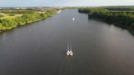 A-two-boats-flows-side-by-side-on-Jeziorak-Lake-in-Poland