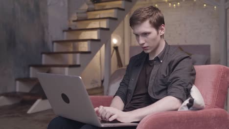 young man working on laptop at home