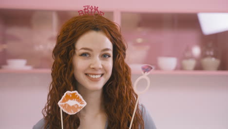 Close-Up-View-Of-Redhead-Woman-With-Headdresses-And-Holding-Cardboard-Decoration