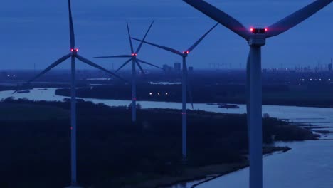 Windmills-Next-To-Oude-Maas-River-At-Dusk-In-Netherlands---Aerial-Drone-Shot