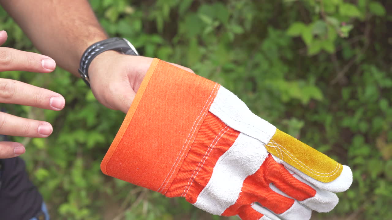 Hand putting on climbing gloves
