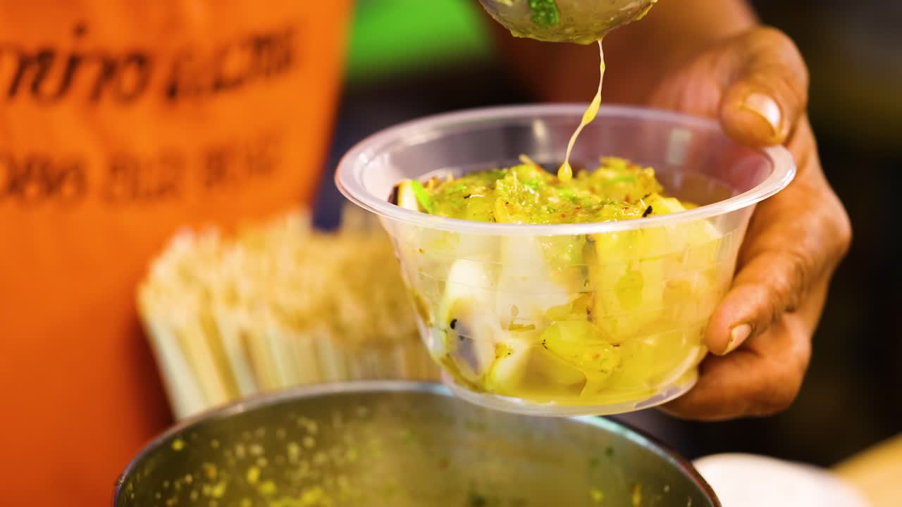 Vendor serving grilled squid at Bangkok market