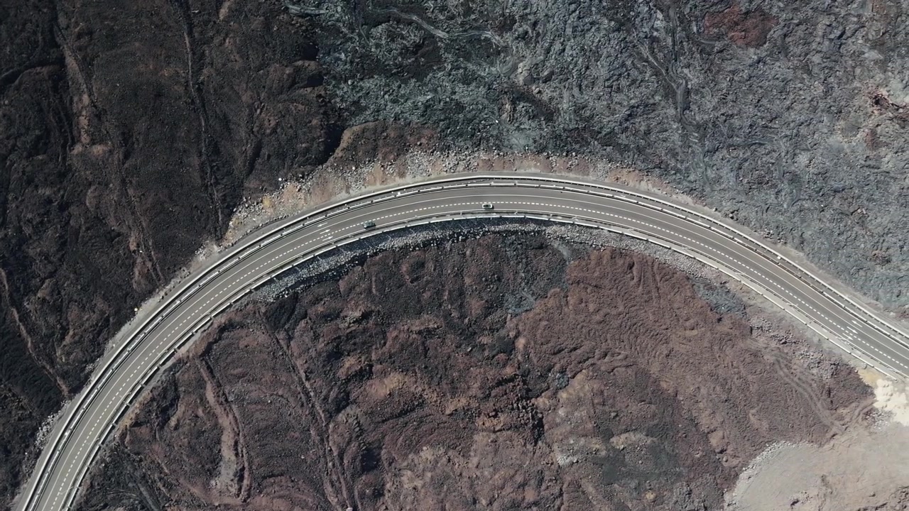 Top down view on highway passing lava field at footstep Taburiente volcano, La Palma, Spain