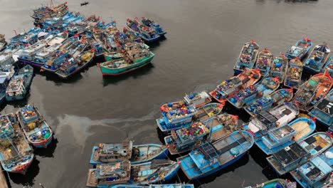 aerial view of traditional fishing boats docked tightly in crowded harbor, vietnam