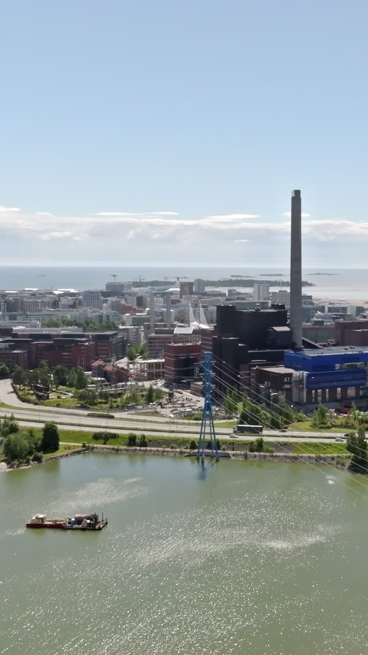 Vertical drone shot rising toward the Ruoholahti cityscape, Helsinki, summer day