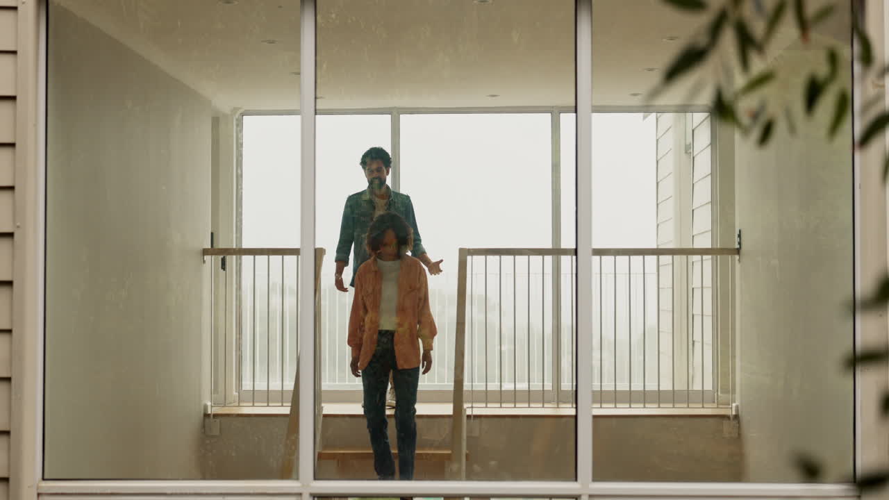 A couple talking on a staircase in a house