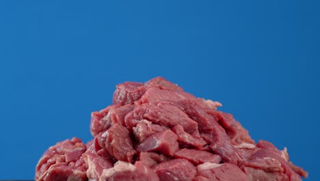 the raw beef cut into pieces slowly rotates.