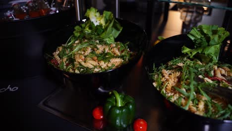 pasta-salad-in-a-black-bowl-in-a-buffet-at-a-hotel-private-event-in-germany