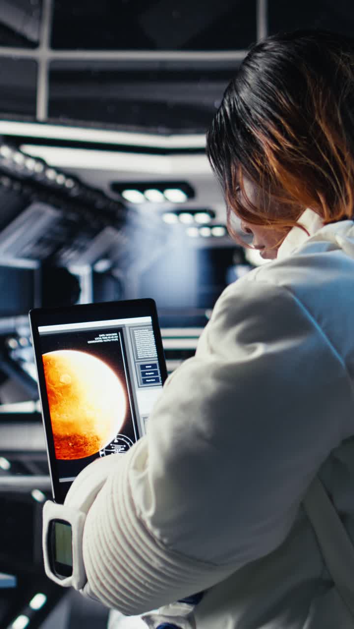 Vertical video Astronaut using tablet to check space station analytics after completing mission