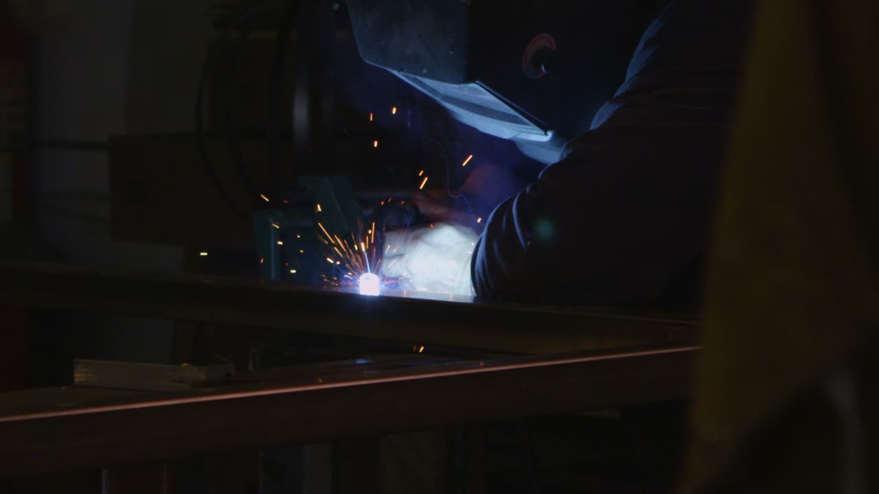 An arc welder welds in a workshop 1