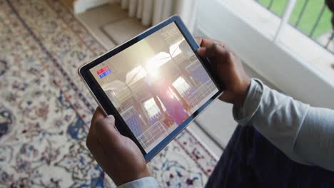 Composite-of-man-sitting-at-home-watching-sports-event-on-tablet