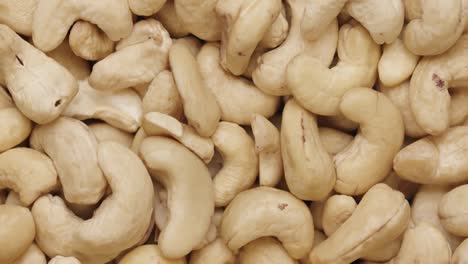 smooth camera movement over a handful of cashew nuts.