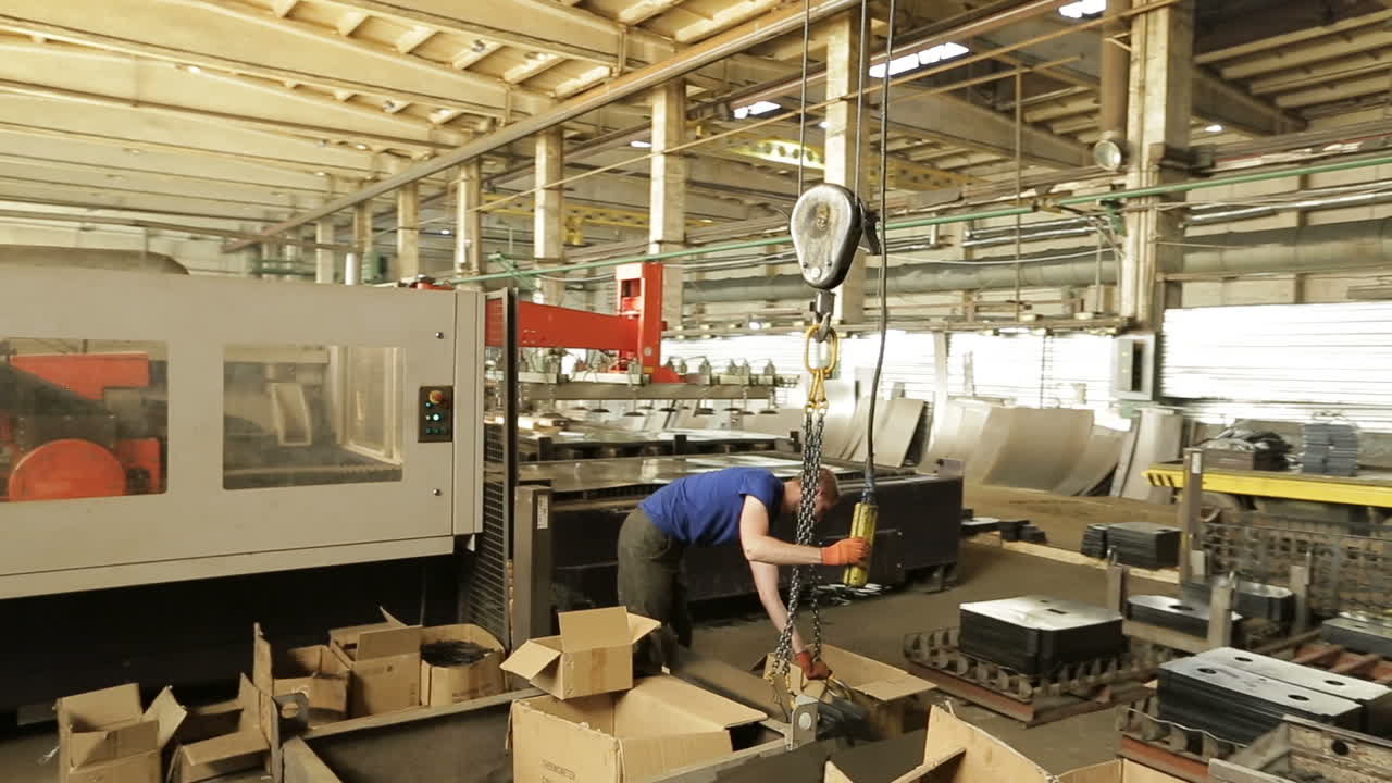 People Working In Factory. BAR, UKRAINE - AUGUST 2017: Worker in protective clothing in factory