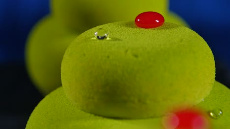 close-up of a green mousse cake with red decor