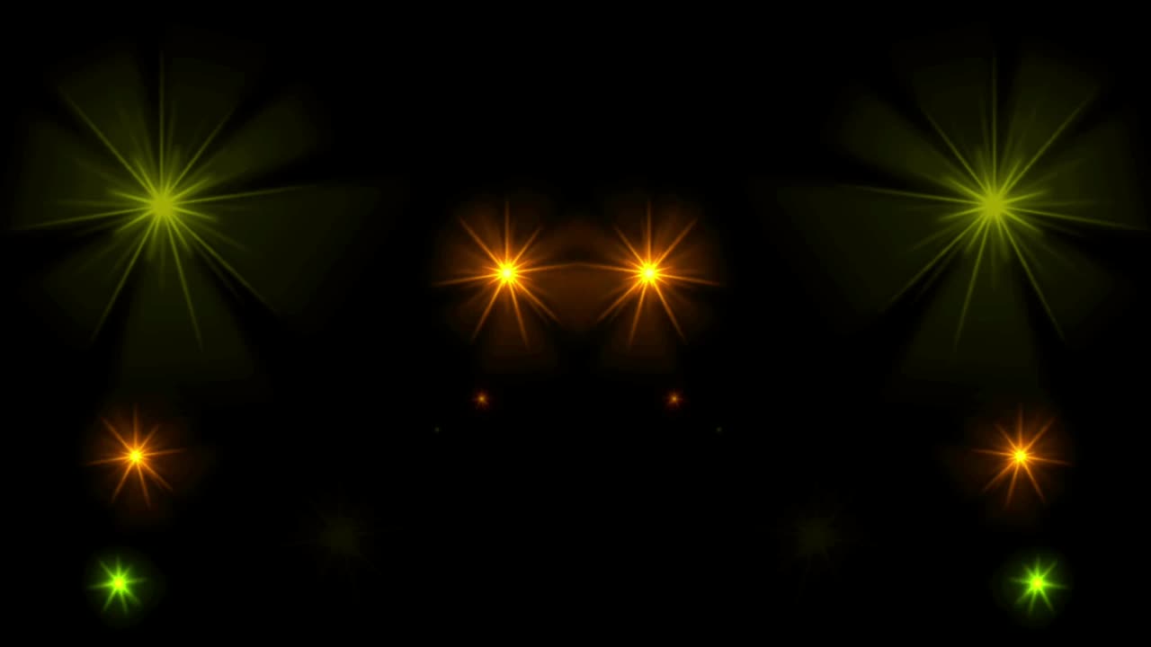 Animation yellow light sparkles on black background.