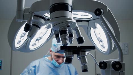 surgeon using microscope in operating room