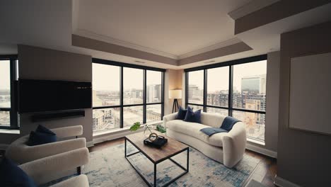 wide-push-in-shot-revealing-a-cozy-living-room-setup-with-white-couches-and-chairs-surrounded-by-large-windows-letting-in-natural-sunlight