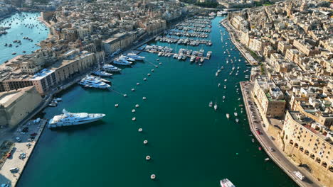 slow ariel drone footage over the harborside of the three cities in malta