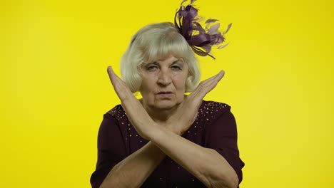 senior old woman asking to stop and showing restrict gestures with hands displeased with something