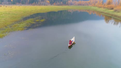 man rowing a boat on a lake 4k