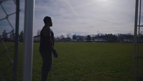 Male-Looking-Into-Distance-and-Stretching---Strong-Athletic-Muscular-Black-Man-Fitness-Outdoor-Training-Preparation-In-4K