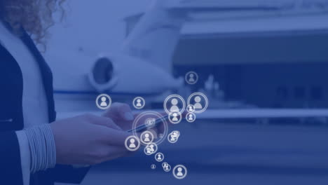 animation of social media icons over caucasian woman using smartphone