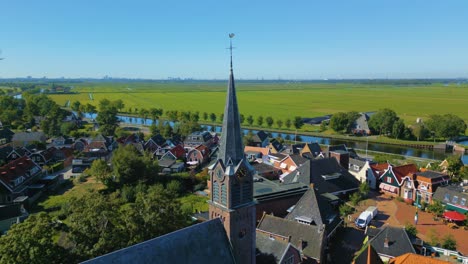 Fixed-shot-of-protestant-church-spire-in-North-Holland-countryside-town