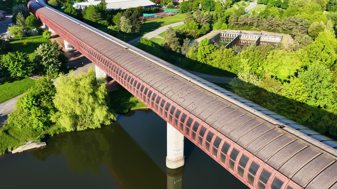 Drone circling the Hůrka–Lužiny metro bridge, sunset in Prague, Czech Republicz
