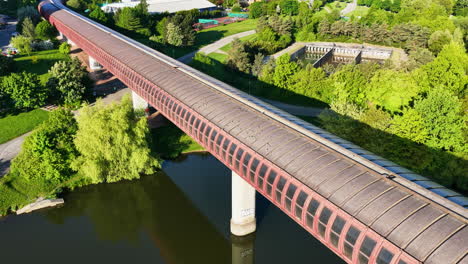 drone circling the hůrka–lužiny metro bridge, sunset in prague, czech republicz